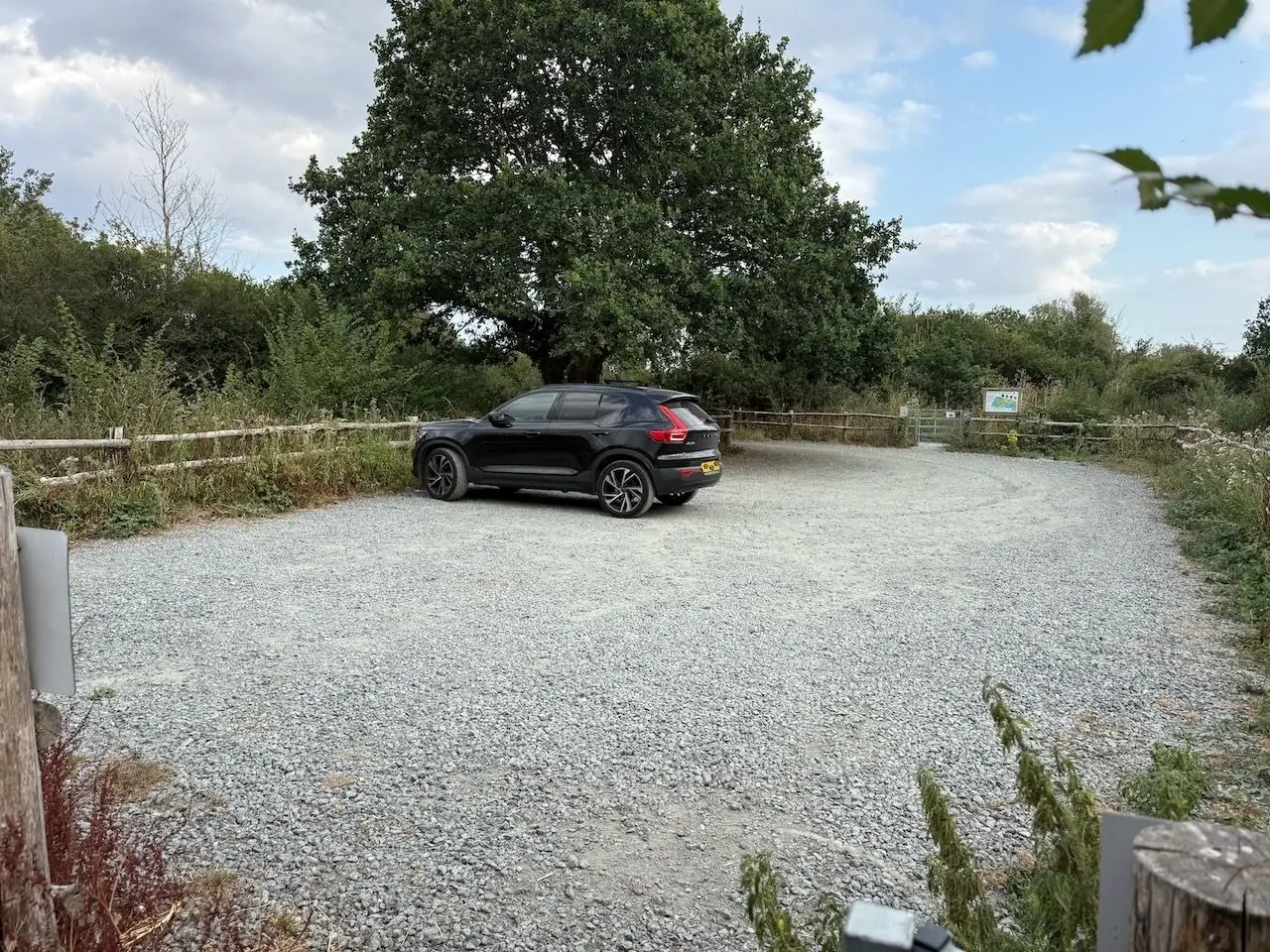 The gravel car park and entrance gate off Chigborough Road